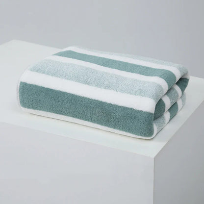 Soft and absorbent green towel with white stripes, crafted from a high-quality polyester/cotton blend. This stylish towel features a thick, plush texture, perfect for quick-drying and gentle on the skin. Ideal for everyday use in bathrooms, providing comfort and functionality with a modern design.