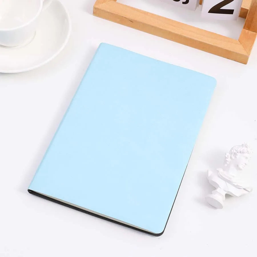 Baby blue cover notebook placed on a table, perfect for note-taking, journaling, and diaries. Features a sleek and minimalist design.