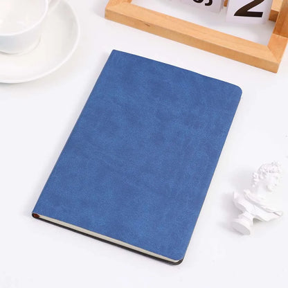 Blue cover notebook placed on a table, perfect for note-taking, journaling, and diaries. Features a sleek and minimalist design.